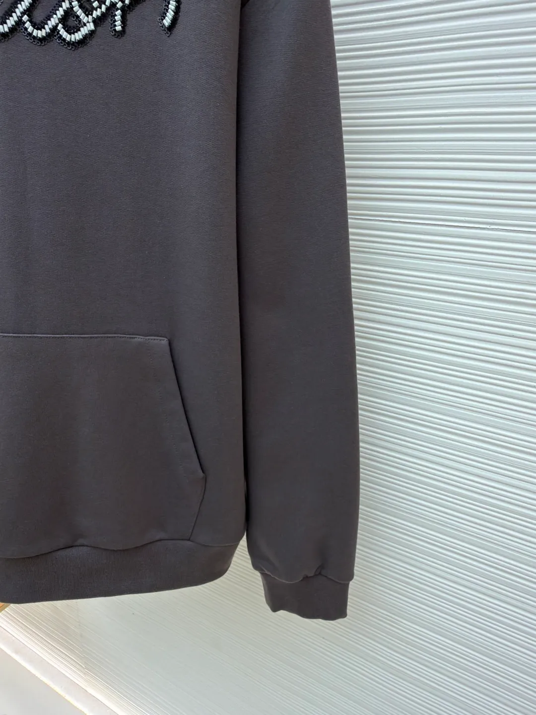 LOUIS VUITTON beaded embroidered letter hooded sweatshirt ●Original version: Purchased and developed by 13078 ●Item number: 1681742-A80 ●Fabric: pure cotton fish scale base fabric ●Technology: Pearl embroidery production ●Color: gray ●Version: fitted version ●Weight: about 805 grams ●Size: XS-S-M-L ●Description: The fabric is made of 26S double yarn + 10S fish scale bottom brushed fabric, weight 380g, with 21S double yarn 2*2 rib, weight 380g. This kind of fabric is treated with fleece to form a layer of soft and plump fluff on the inside; the improved fish scale knitting method forms a delicate concave and convex texture on the bottom surface, similar to the arrangement of fish scales. Effectively increases the air storage layer and improves thermal insulation performance. The front of the fabric is smooth and smooth, while the back is soft and waxy. It has excellent moisture absorption, breathability, wrinkle resistance and drape, and is thicker and crisper than ordinary sweatshirt materials. It gives clothes excellent warmth retention, breathability and skin-friendly touch. The Vuitton script on the chest is embroidered with beads. During the embroidery process, tiny beads are fixed on the fabric together with embroidery thread. The direct characteristics brought by this process are a strong three-dimensional sense, a unique sense of weight and a reflective effect that changes with the light. The overall wiring is straight and delicate, the fabric is comfortable and soft, and the color is consistent without color difference. It can be matched with the same style to create a fashionable look and control various occasions. Customized accessories, complete with three standards, same style for men and women!